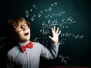 tinywow_Genius boy in red glasses near blackboard with formulas_52207535.jpg